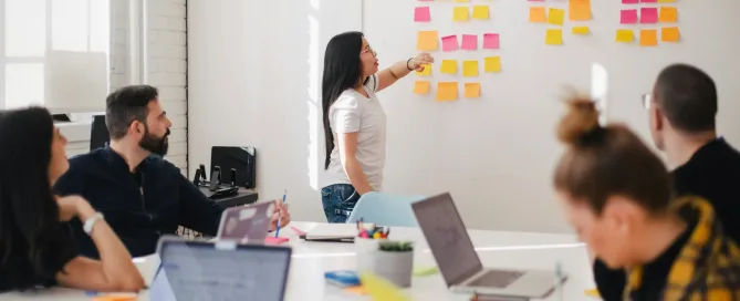 software development outsourcing team projecting in a room with a board