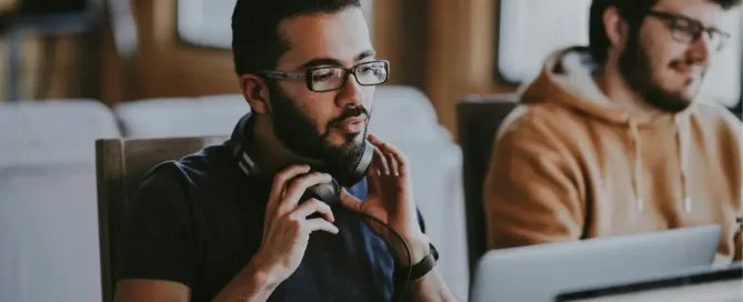 AI Hallucinations: man wearing eyeglasses and headphones beside smiling man Party Sami from the Unsplash Team working away, with a side helping of ‘le Phantom’ Tim Bones