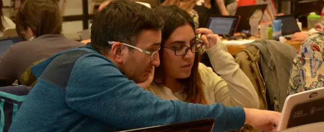 Cloud Migration: a group of people sitting at a table with laptops discuss their options