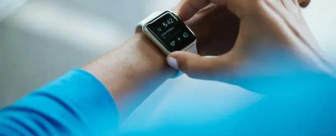 Nearshore App Development for HealthTech Companies: person clicking Apple Watch smartwatch