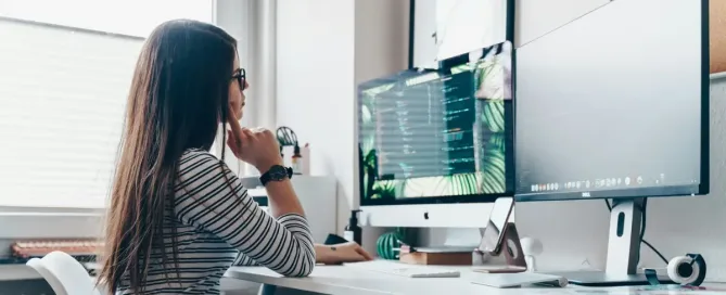 User Interface Tech Stacks: girl using desktop computer in room designs an interface