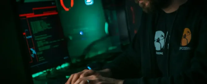 compliance-focused sdlc gamer dressed in keep coding black hoodie types on keyboard