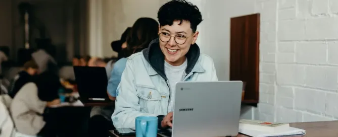 Cloud Models: smiling man sitting and using Samsung laptop near people