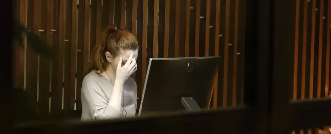 job dissatisfaction: a woman sitting in front of a laptop computer looking anxious, burnout, stressed, and stressed out