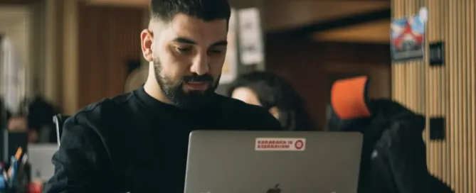 Leading Remote Teams: man in black crew neck shirt using macbook