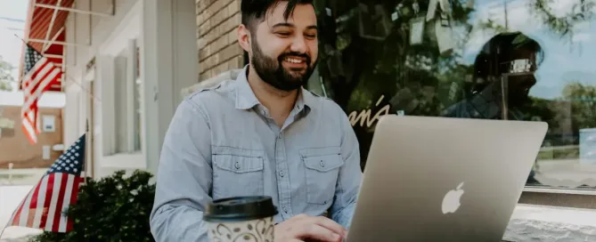 Build Tools: man in gray denim dress shirt smiling while using MacBook Pro