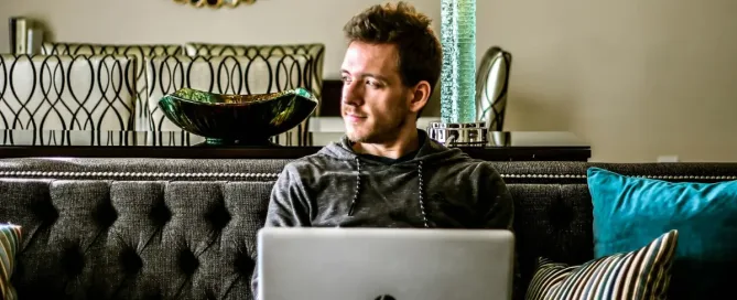 debugging tools: man looking aside with HP laptop on his lap