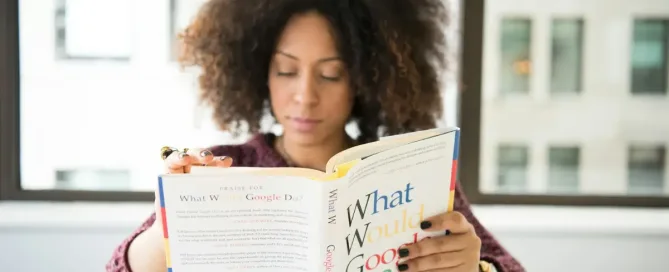 lead distributed teams: woman reading What Would Good Do? book