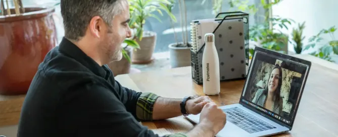 questions to ask candidates: man in black sweater using macbook pro working in an office on a virtual call