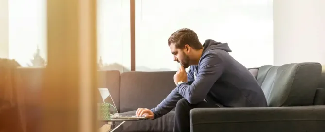 Think Like a Tech Entrepreneur: man sitting on sofa facing laptop computer