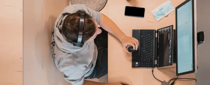 ai-assisted coding: woman in blue shirt sitting on chair using laptop computer