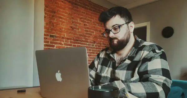 coding burnout: a frustrated-looking man sitting in front of a laptop computer