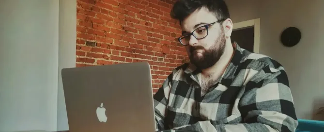 coding burnout: a frustrated-looking man sitting in front of a laptop computer