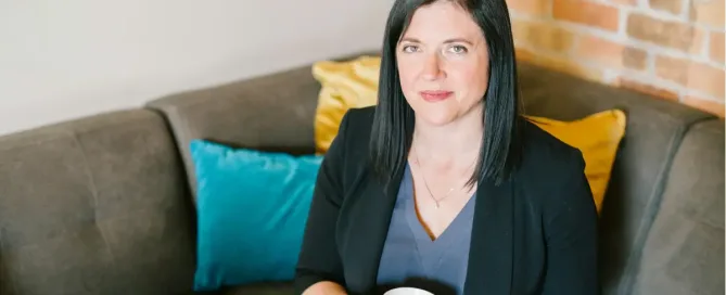 labor laws and outsourcing: female lawyer holding cup of coffee sitting on sofa