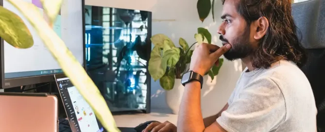 remote work setup: young software engineer with a man looks attentively at the screen