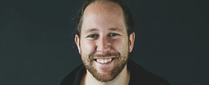 ruby on rails developers: man in black jacket smiling