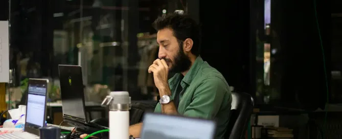 tech debt: tired-looking man sitting in front of a laptop computer