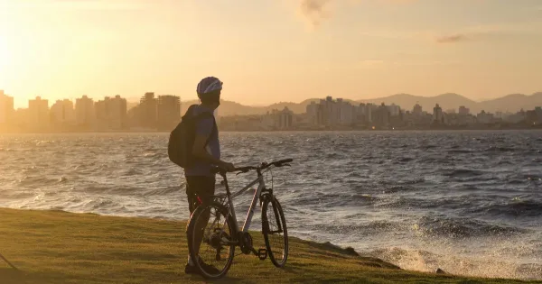 Countries in Latin America: Engineer and his bike overlook Florianopolis sea-bound skyline