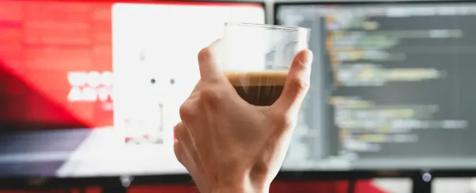 managing remote-first teams: person working from home, holding clear drinking glass with beverage inside