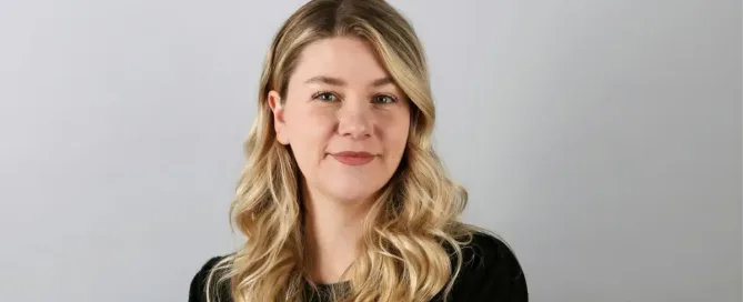 digital currency: a woman with long blonde hair wearing a black shirt smiles at camera