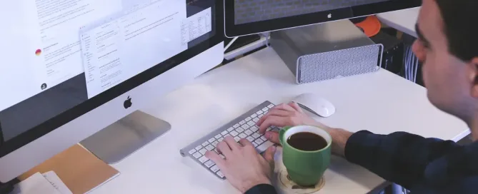 how the internet works: man drinking coffee in front of 3 monitors