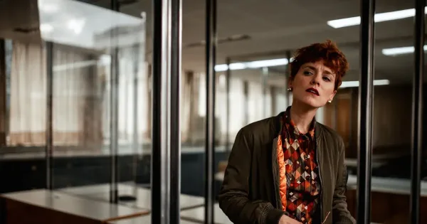 zero trust security: curious boss lady looks disapprovingly through glass doors