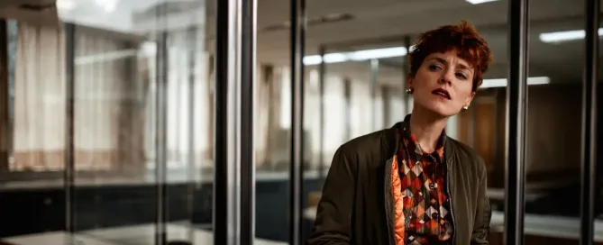 zero trust security: curious boss lady looks disapprovingly through glass doors