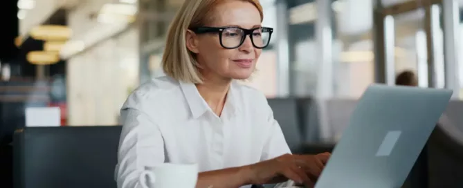 Delivery Manager Hiring: a delivery manager sitting at a table using a laptop computer