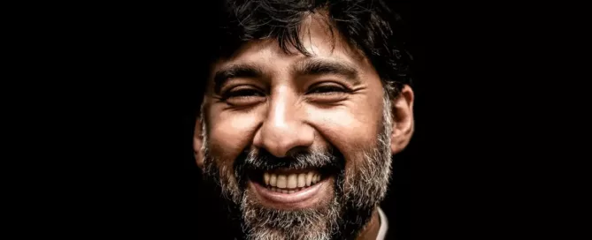 Maintain High Code Standards: CTO wearing black and white top smiles at camera, at peace