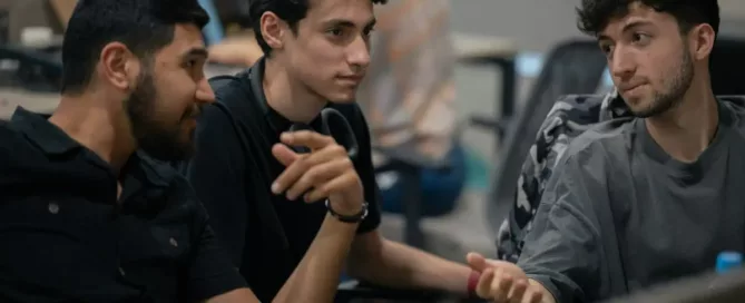 Stable Nearshore Teams: A group of software engineers sitting next to each other, discussing a technical request