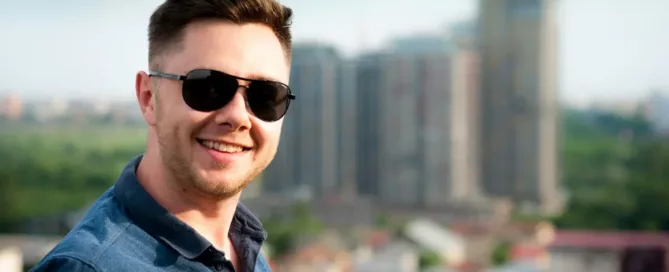 Staffing Model in Tech: Tech founder wearing blue polo shirt with building background