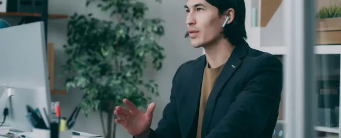 micromanaging: a stressed man in a suit is talking to someone on a zoom call
