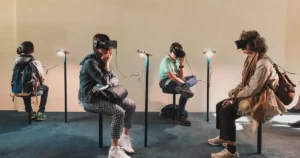 Diverse group of people using VR headsets in a gallery setting, representing user-centered design in AR/VR development.